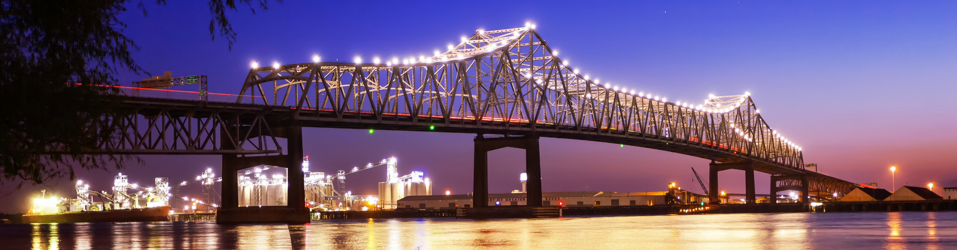 Mississippi river bridge at night with lights on.
